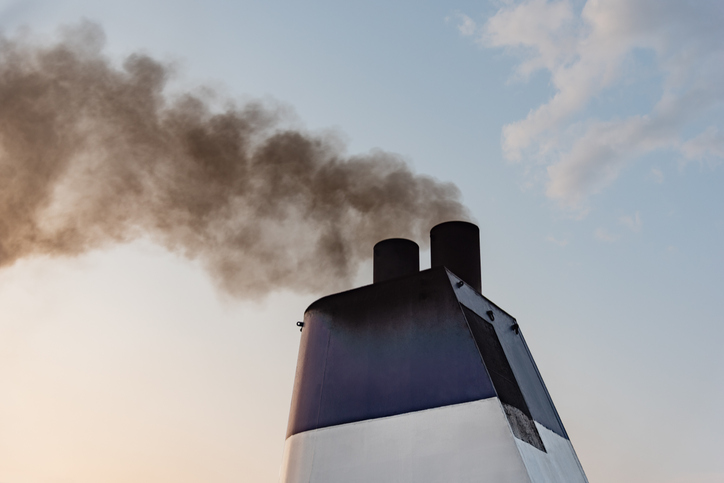 Ferry boat exhaust pipe blowing smoke in the sky