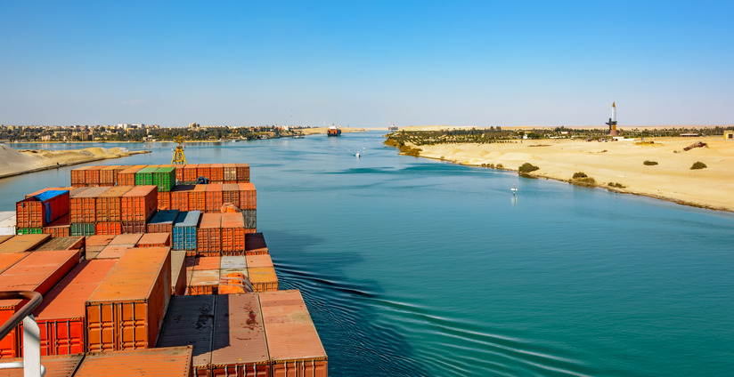 Industrial container ship passing through Suez Canal with ship’s